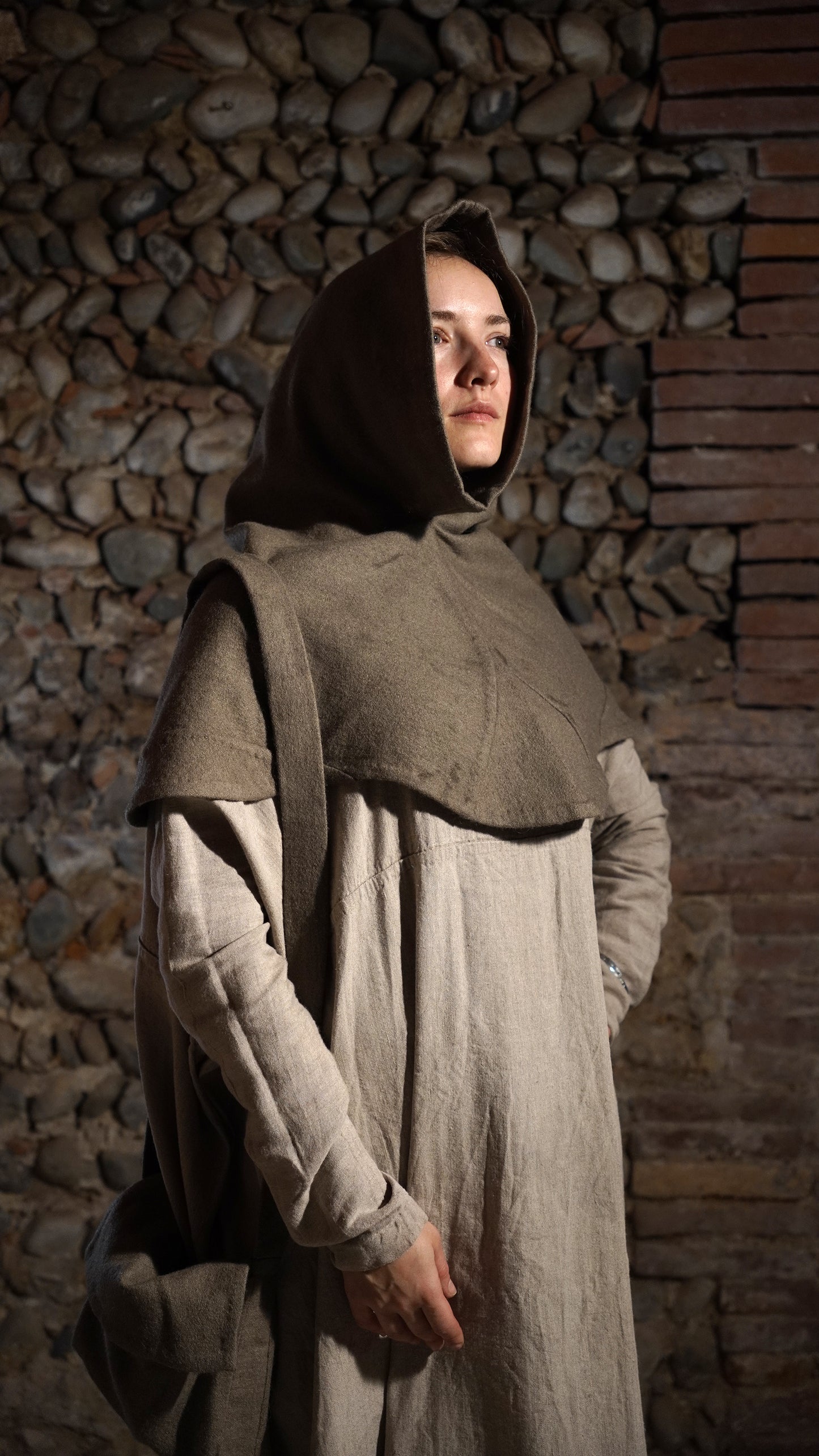 Woman wearing Bocksten hood and a bag