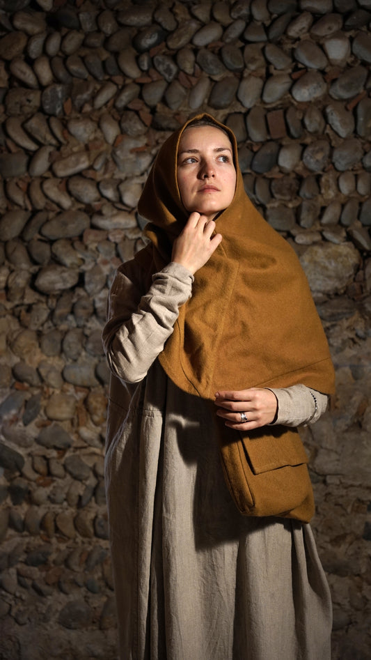 Woman wearing Roman hood and a bag