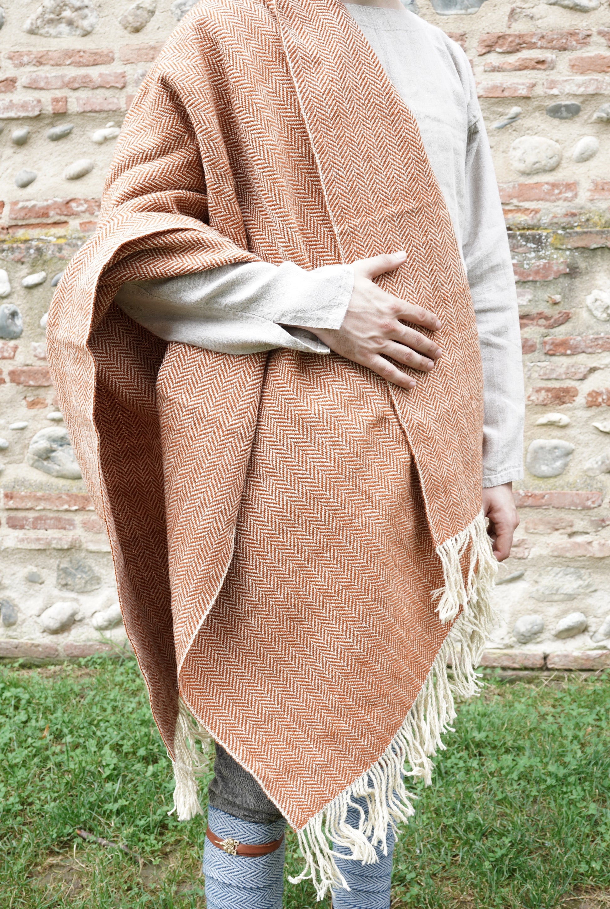 man dressed with Handwoven Herringbone Twill Cloak held by hand