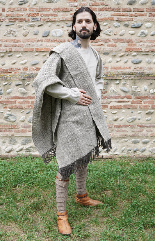 man dressed with Handwoven Herringbone Twill Cloak on middle ages clothes held by hand