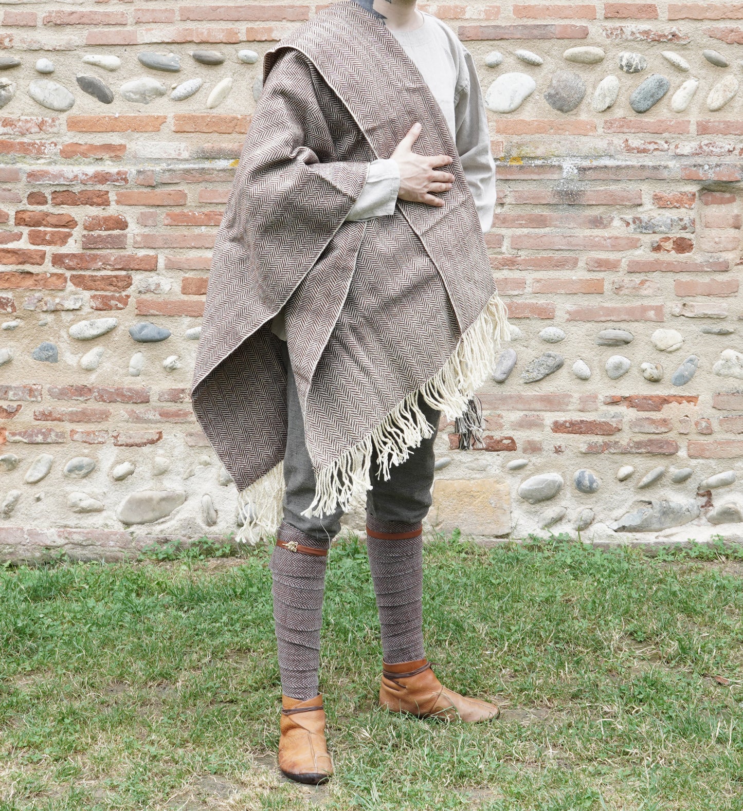 man dressed with Handwoven Herringbone Twill Cloak held by hand