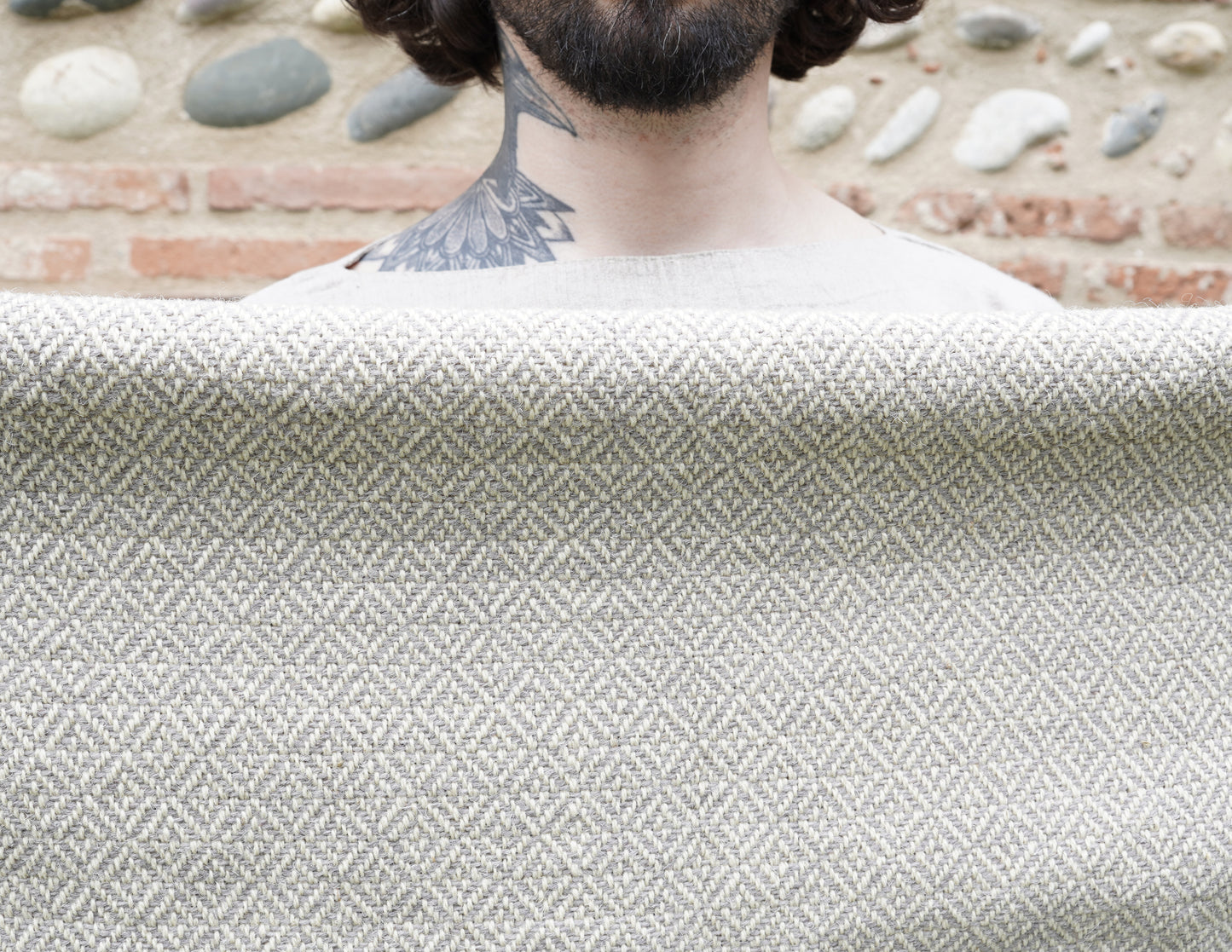 Handwoven Diamond Twill Cloak held by man behind